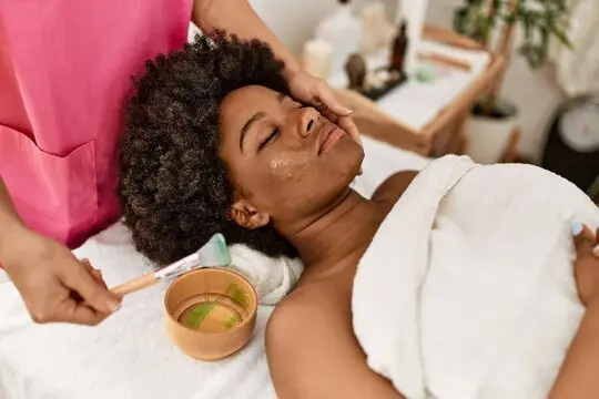 Woman receiving a professional facial treatment at a spa