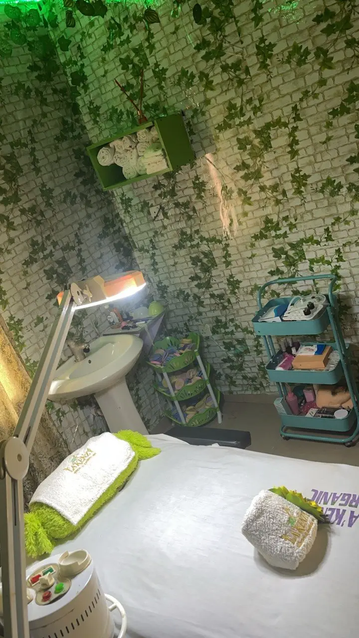 Facial treatment room at La'kenzy Skincare & Aesthetic SPA in Mowe, Ogun State with treatment bed, skincare equipment, towels, and professional supplies.