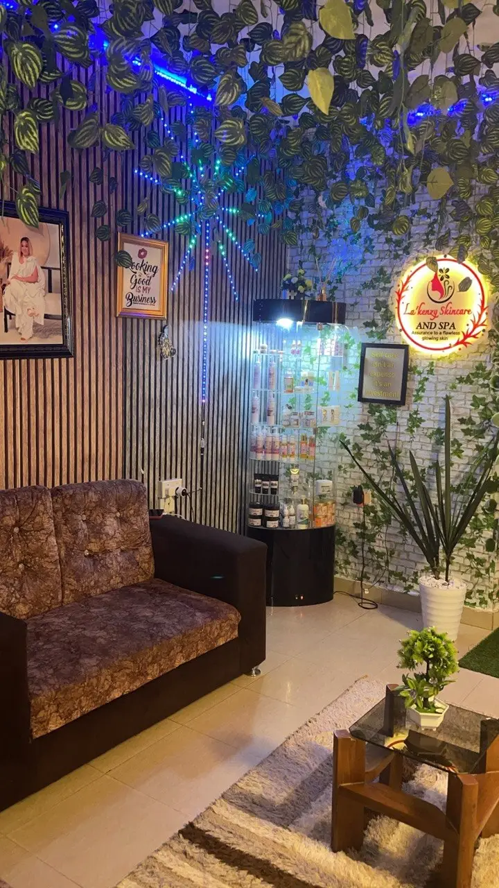 Stylish waiting area at La'kenzy Skincare & Aesthetic SPA in Mowe, Ogun state with comfortable seating, skincare products, botanical décor, and ambient lighting.