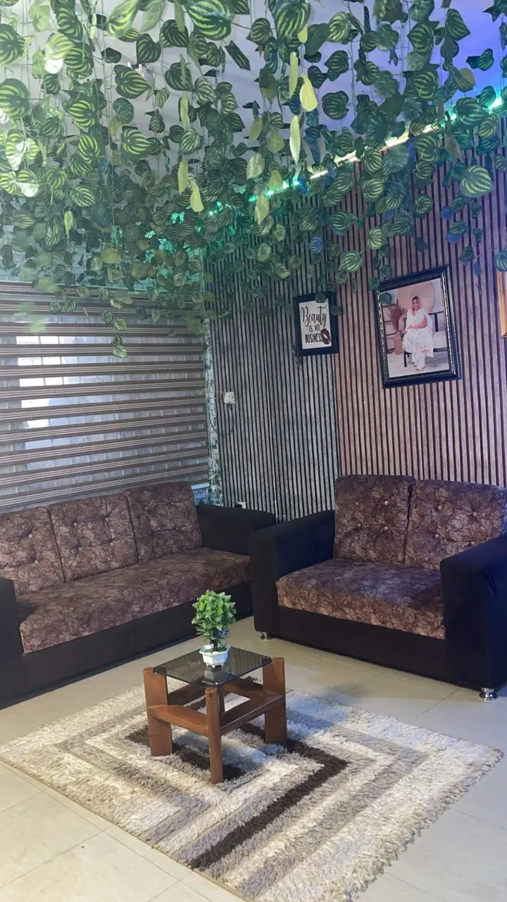 Comfortable and stylish waiting area at La'Kenzy Skincare & Aesthetic SPA in Mowe, Ogun state with lounge seating and botanical decor